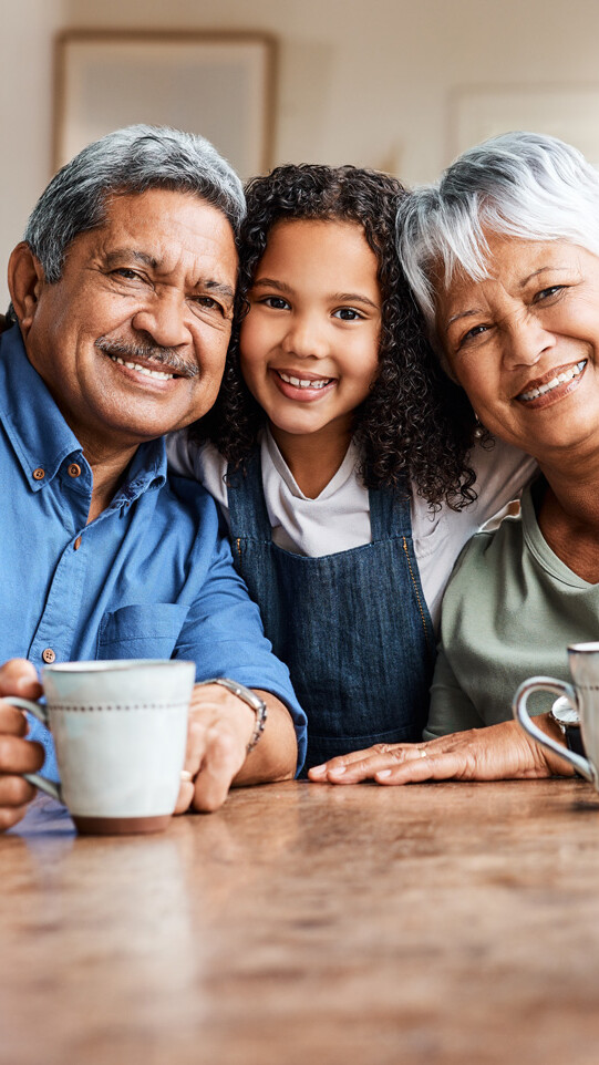 A young girl smiling with her grandparents
